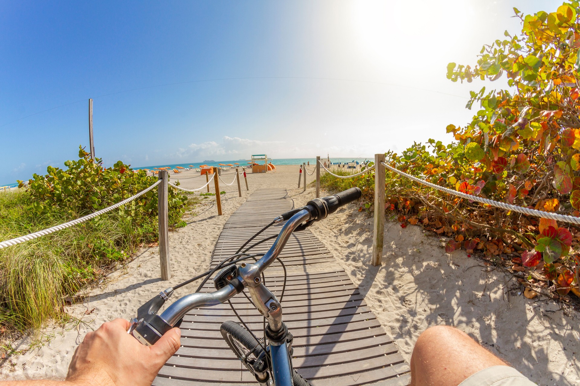 POV Point of view shot of a young sport man riding a bicycle to the beach in South Beach, Miami Beach, Miami, South Florida, United States of America